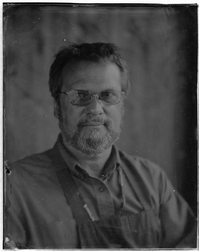 Mark Osterman
This plate is a collodion negative that I took of Mark Osterman at Lacock Abbey in Wiltshire England. It was my first experience of wet-plate. He had originally intended to do a portrait of me but I insisted that I do one of him as well. The original plate was broken a few months later but I had a scan of it.
